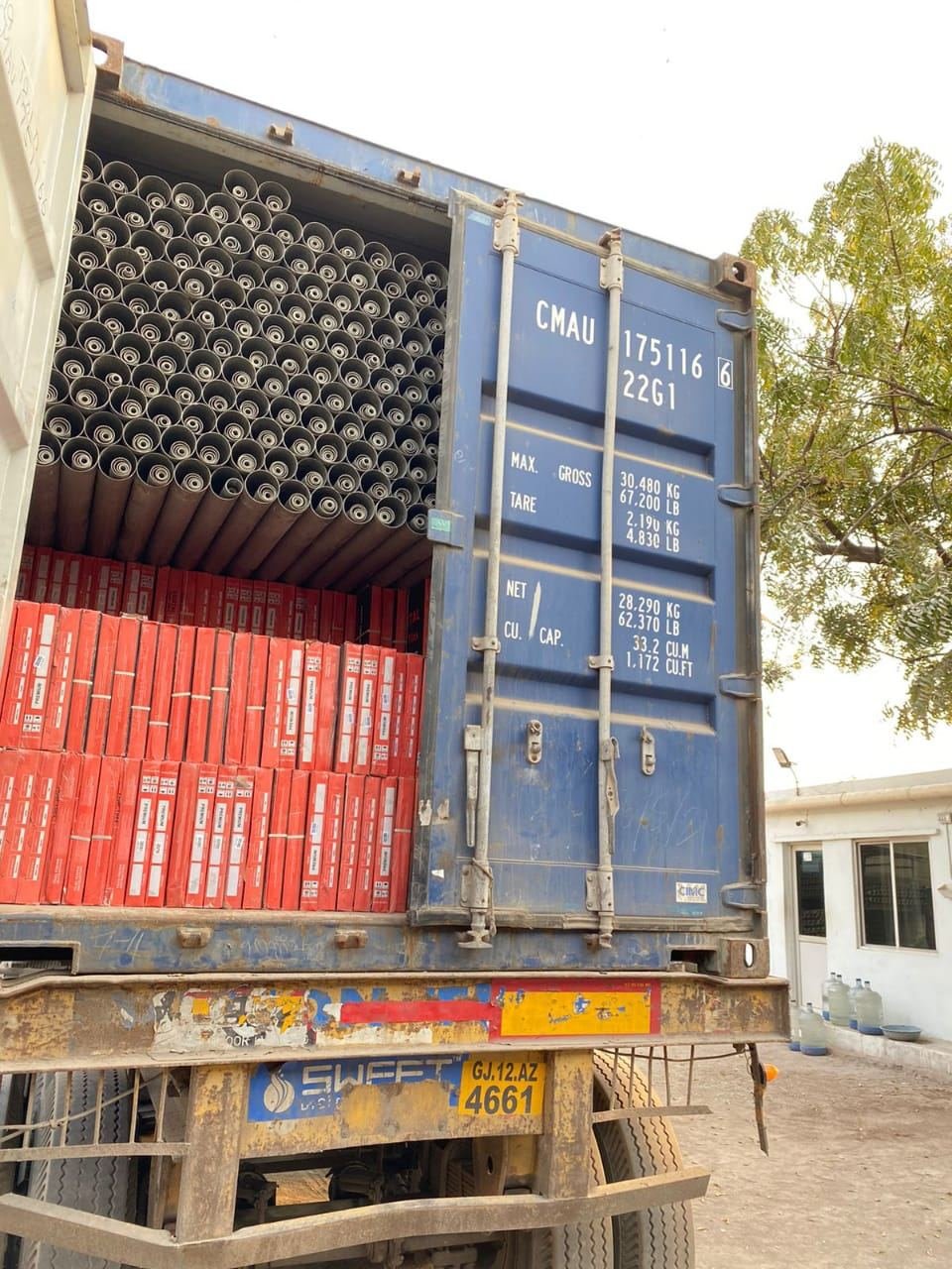 PVC pipe bundles and cartons loaded into a container